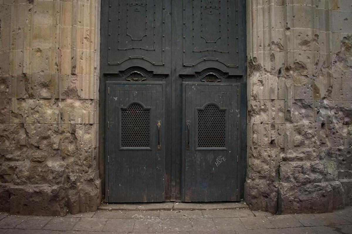 una antiga porta de fusta en un edifici de pedra