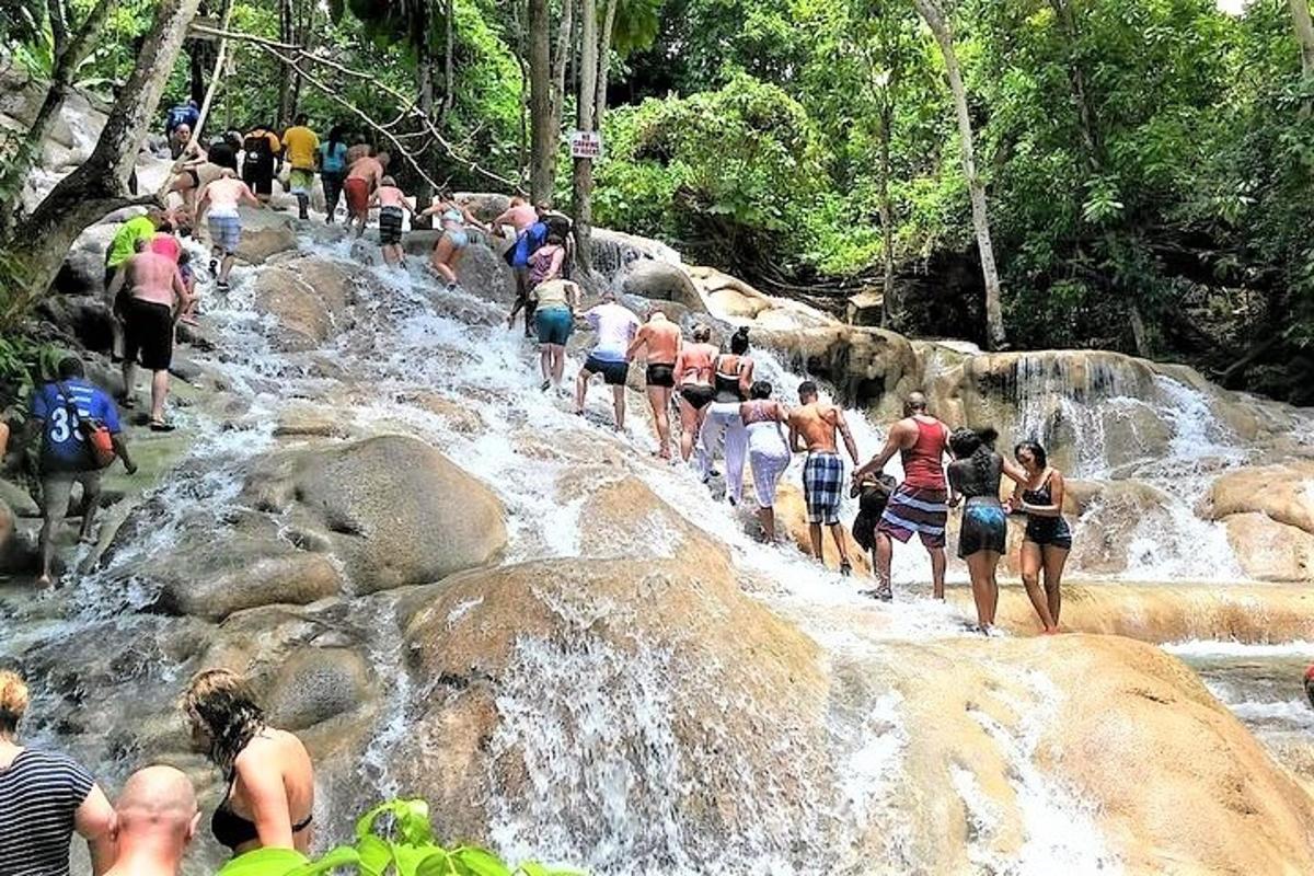 a group of people walking down a waterfall