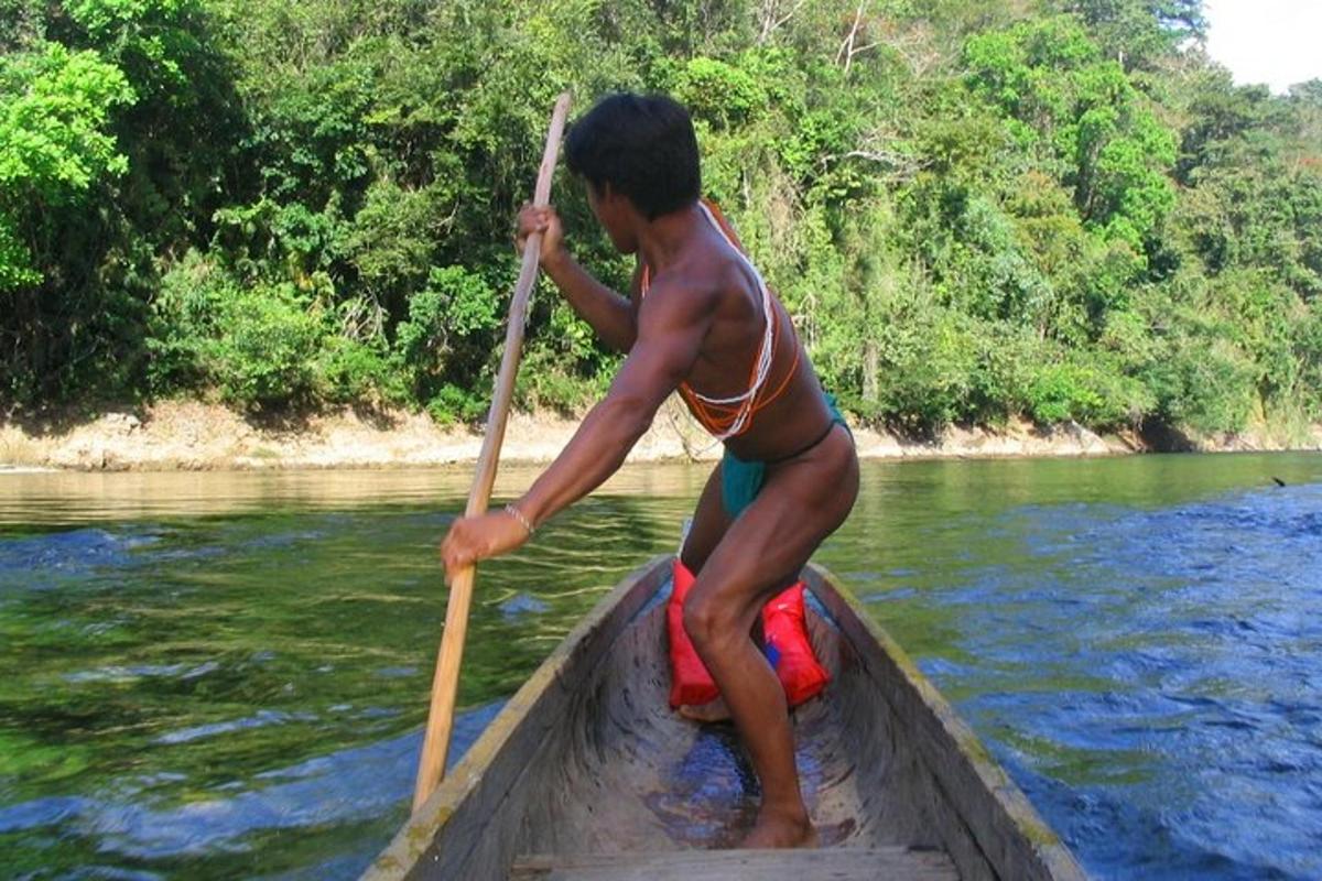 a man in a boat with a paddle in the water