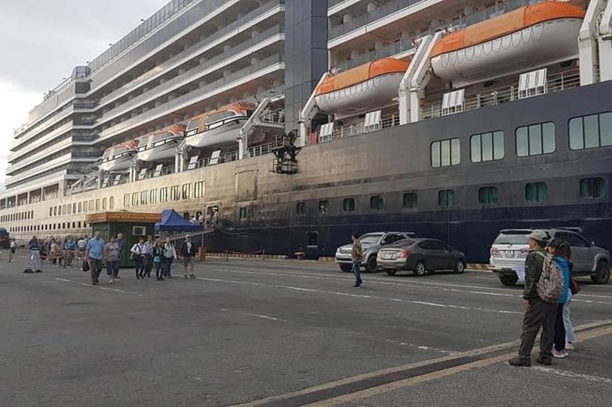 sebuah kapal pesiar besar diparkir di depan sebuah gedung