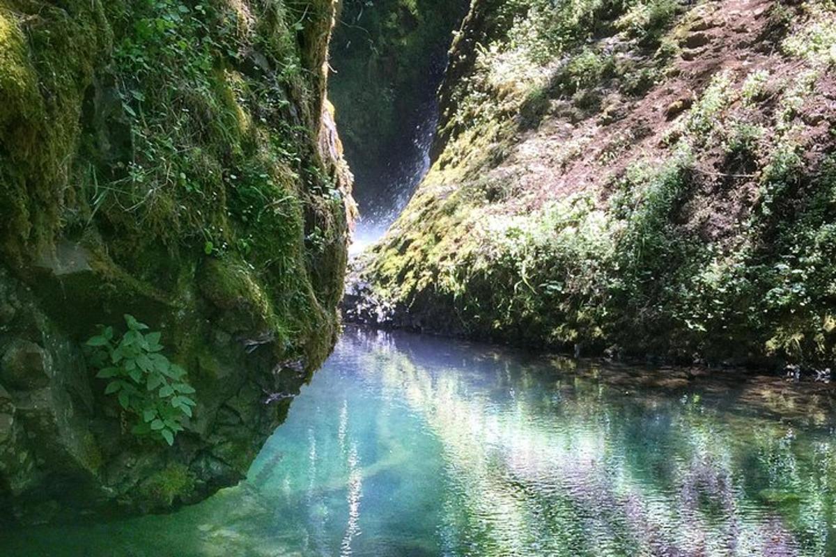 a pool of water in a river between two rocks