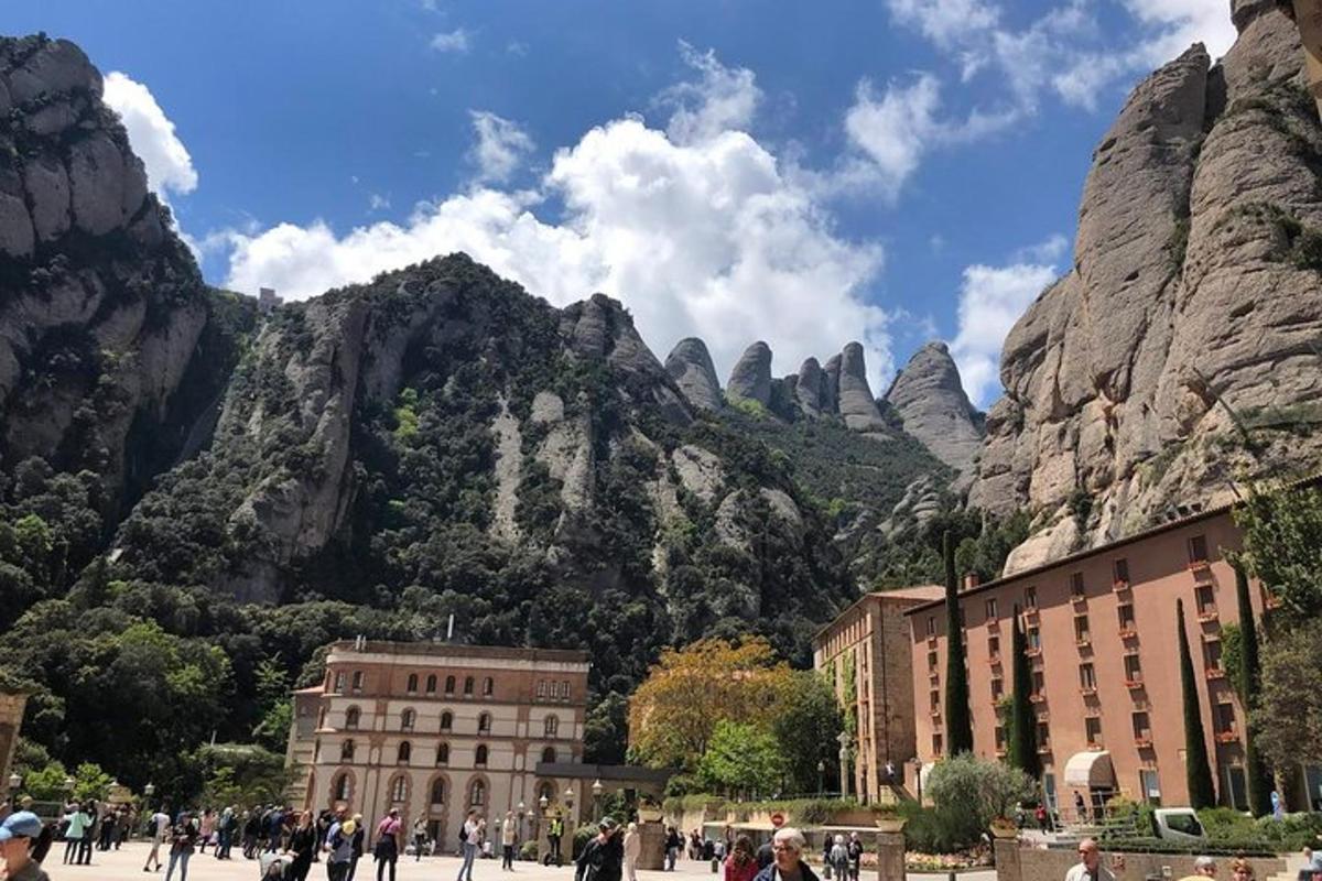 a mountain with people walking in front of a building
