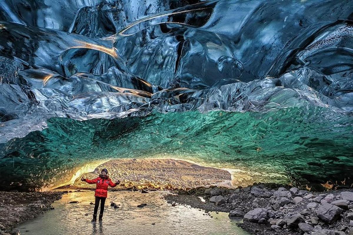 a person standing in the water in a cave