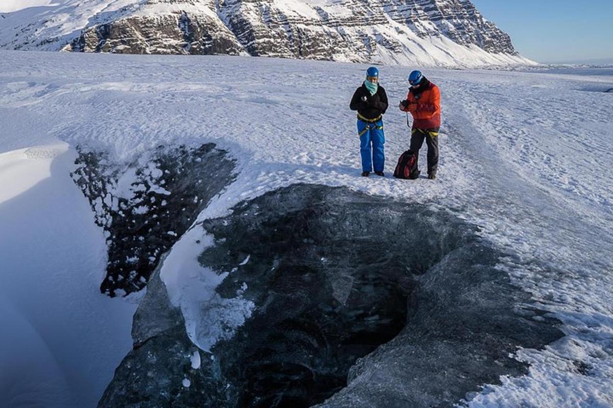 two people standing on a chunk of ice in the snow