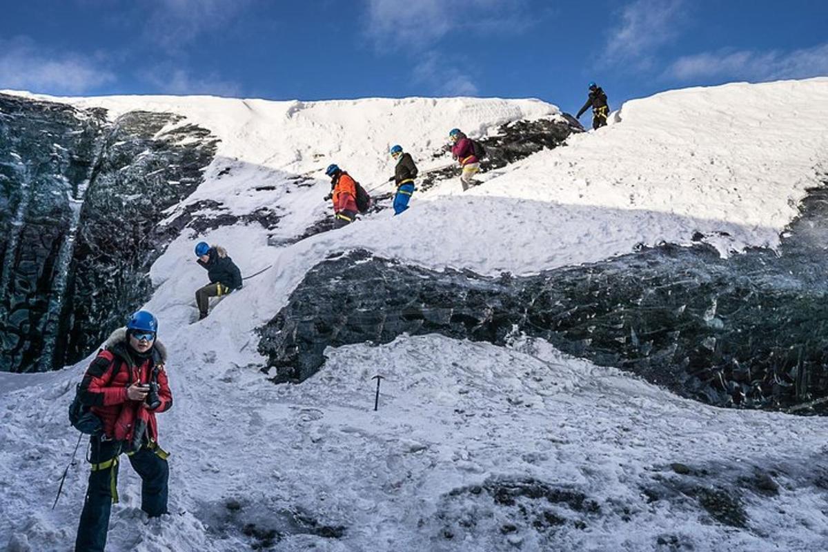 a group of people standing on a snow covered mountain