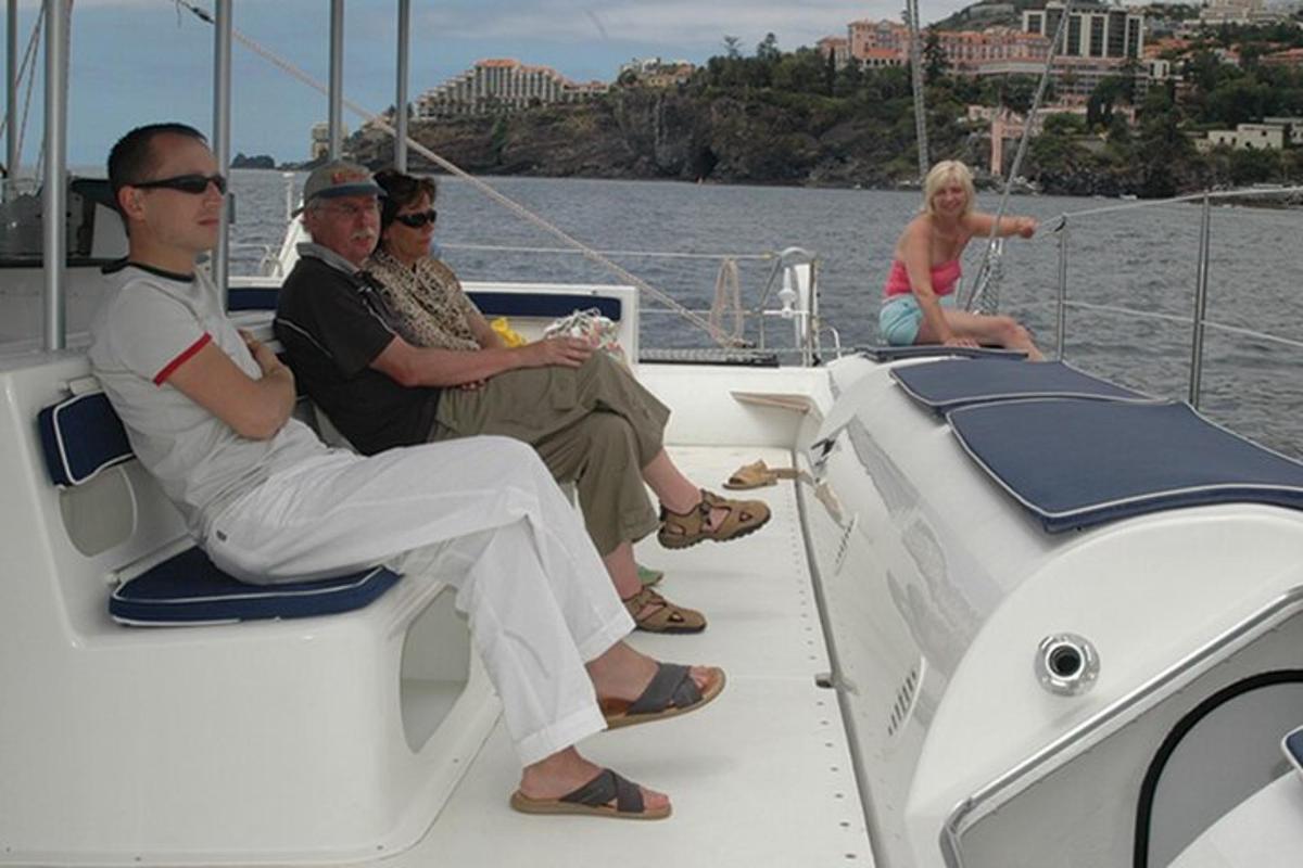 a group of people sitting on a boat in the water