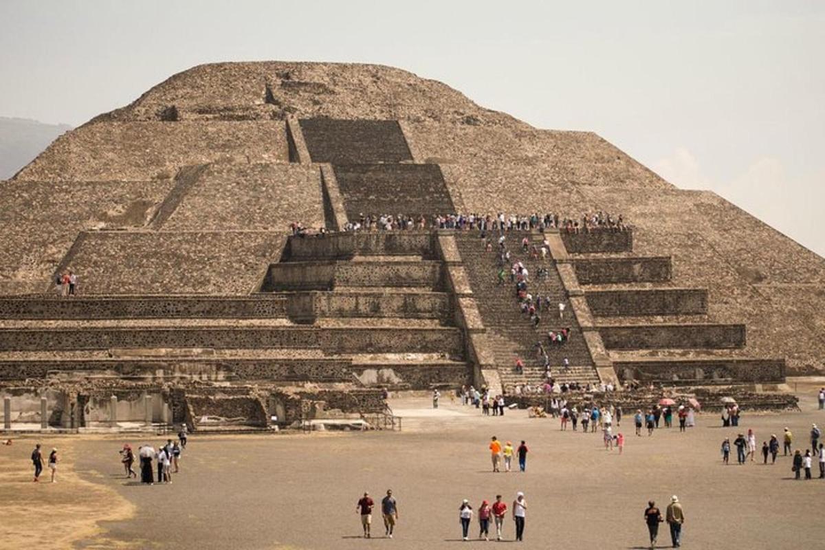 a group of people standing in front of a pyramid