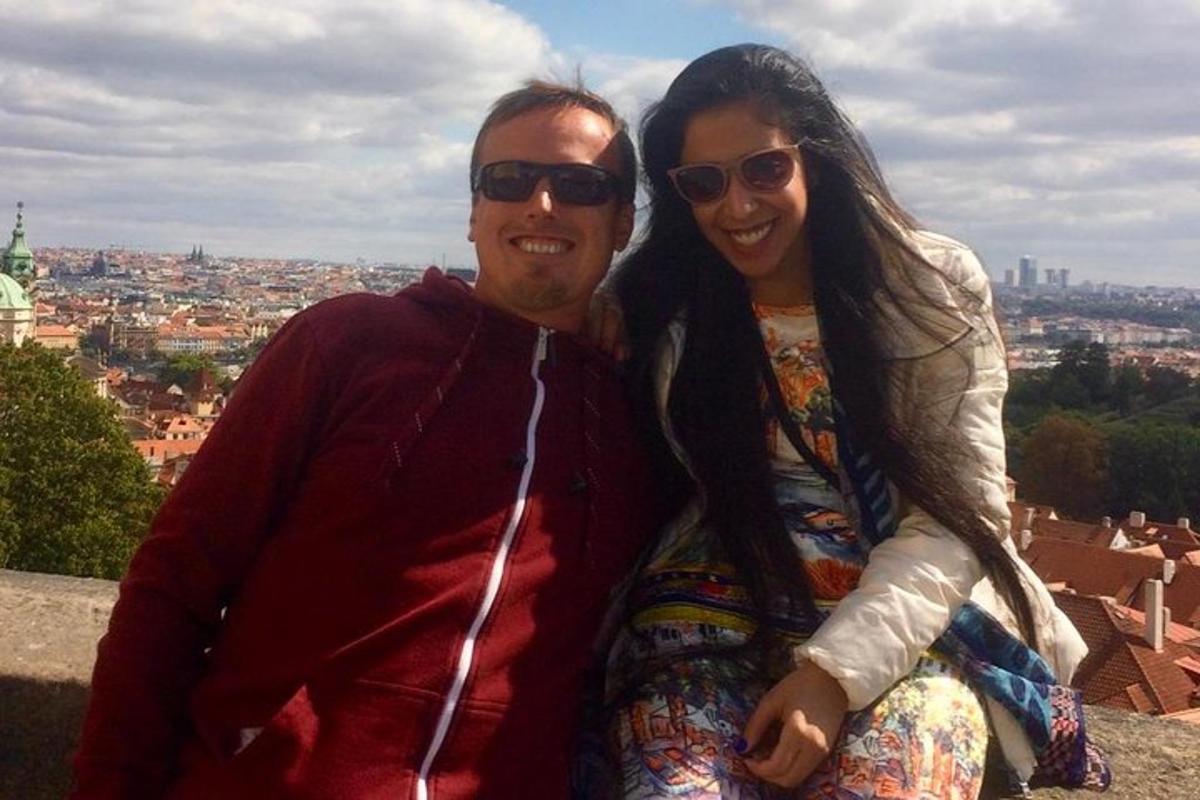 a man and a woman sitting on top of a building