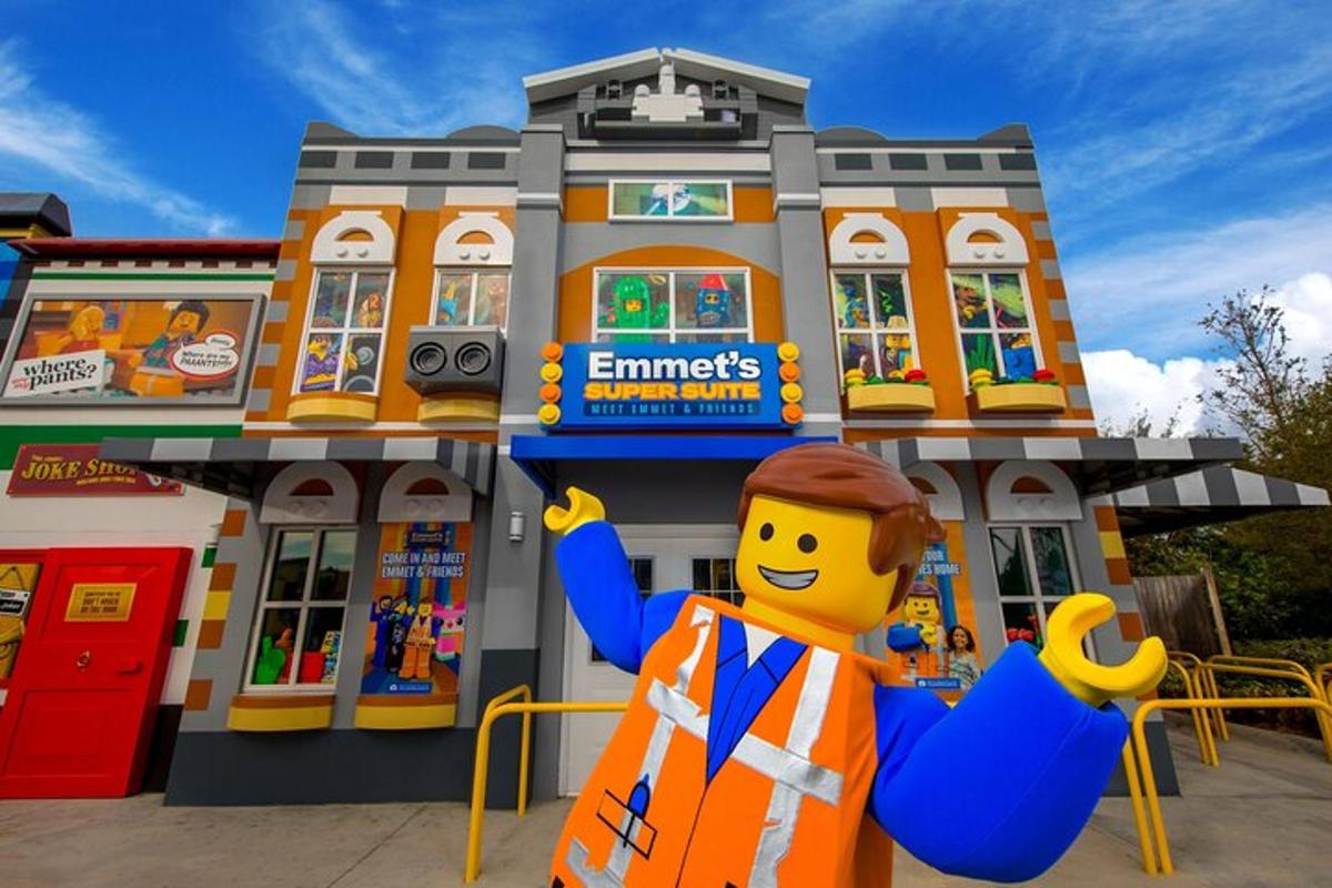 a lego man in front of a lego building
