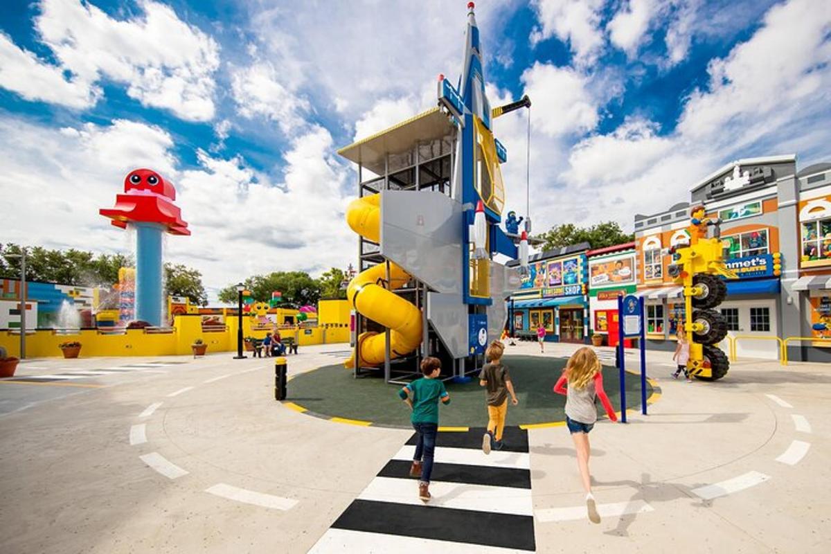two children playing in a playground at an amusement park