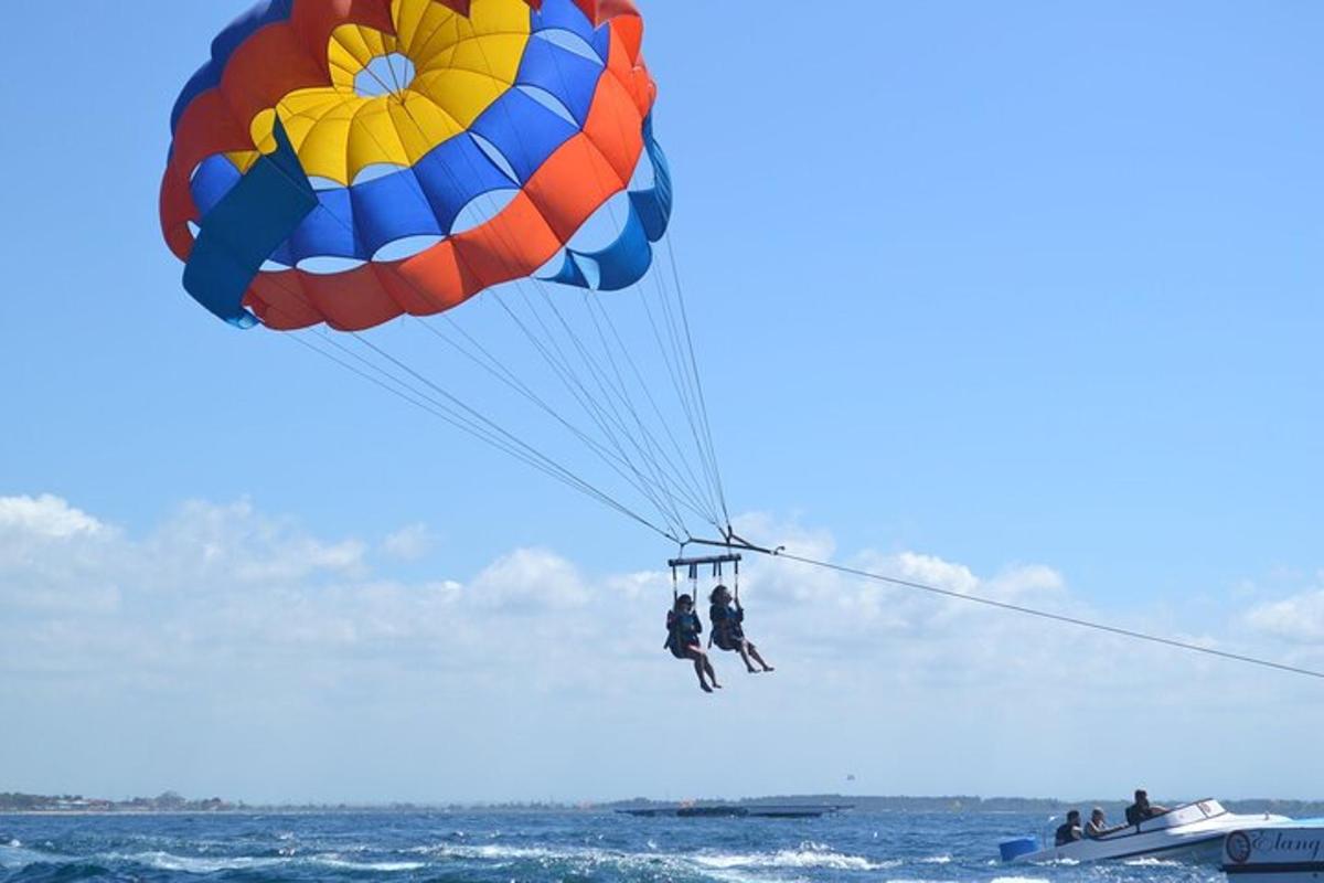 two people on a parachute over the ocean