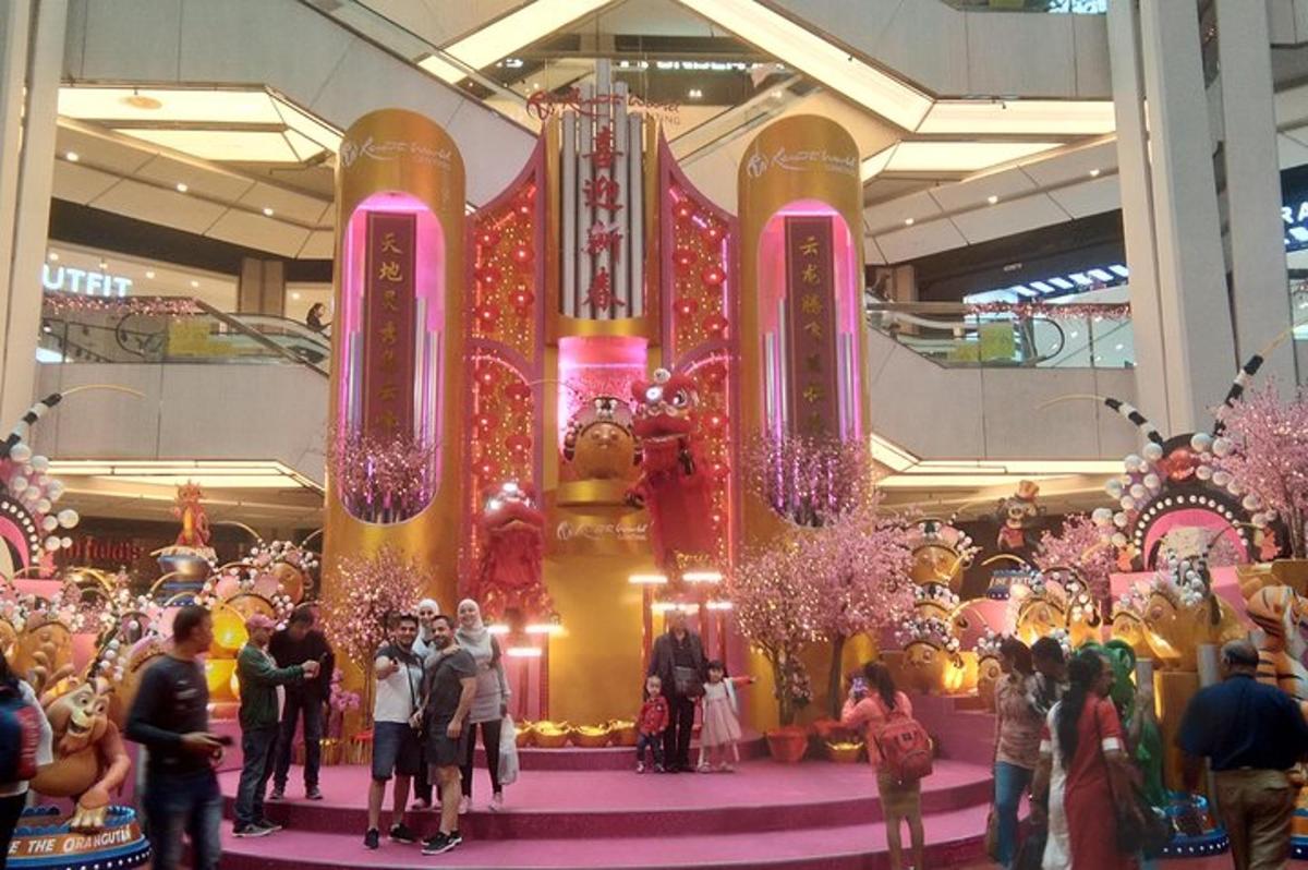a group of people standing around a display in a mall