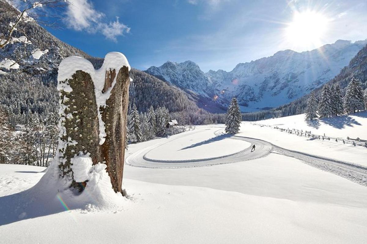 a snow covered sign on a road in the mountains