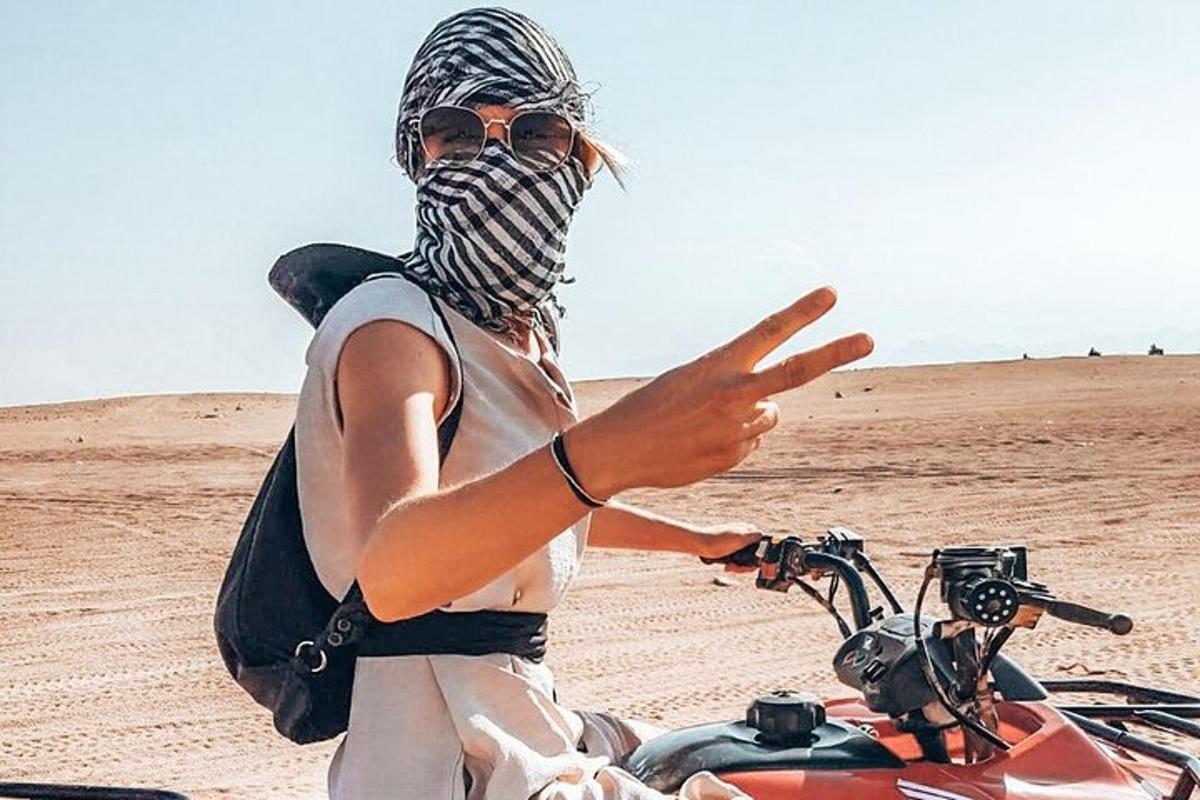muž jedoucí na motorce v poušti