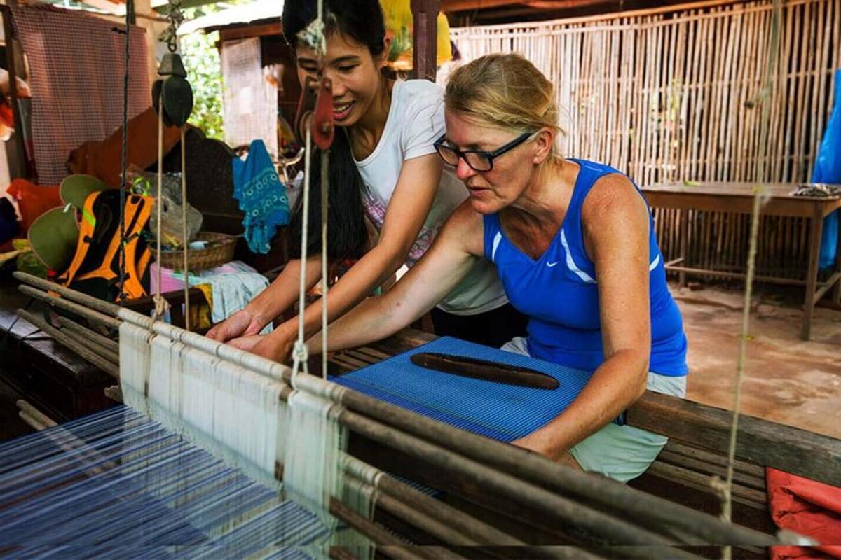 two women are working on a bird cage