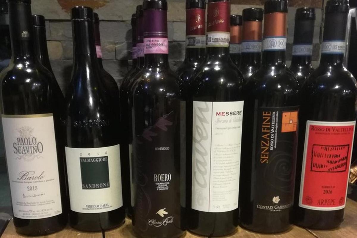 un mucchio di bottiglie di vino appoggiate su uno scaffale