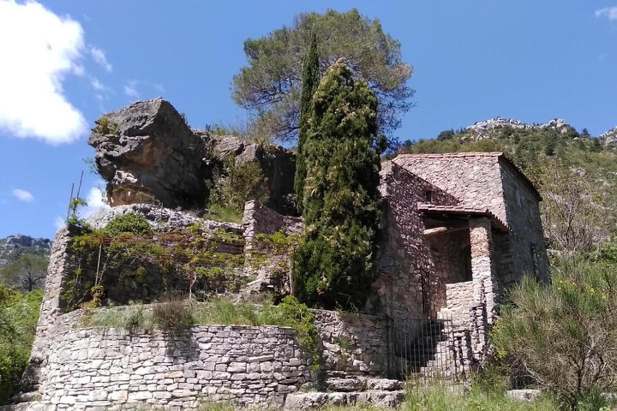 an old stone building on top of a hill