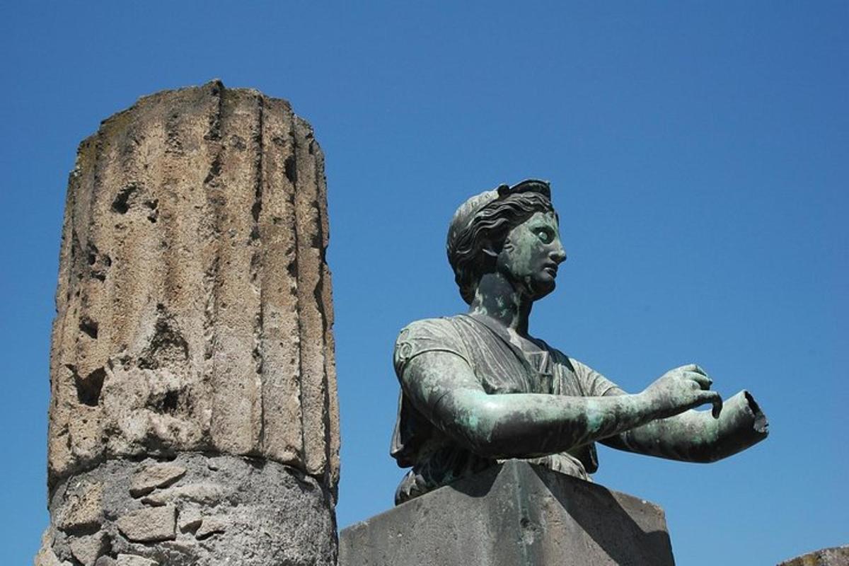 a statue of a woman sitting on top of a monument