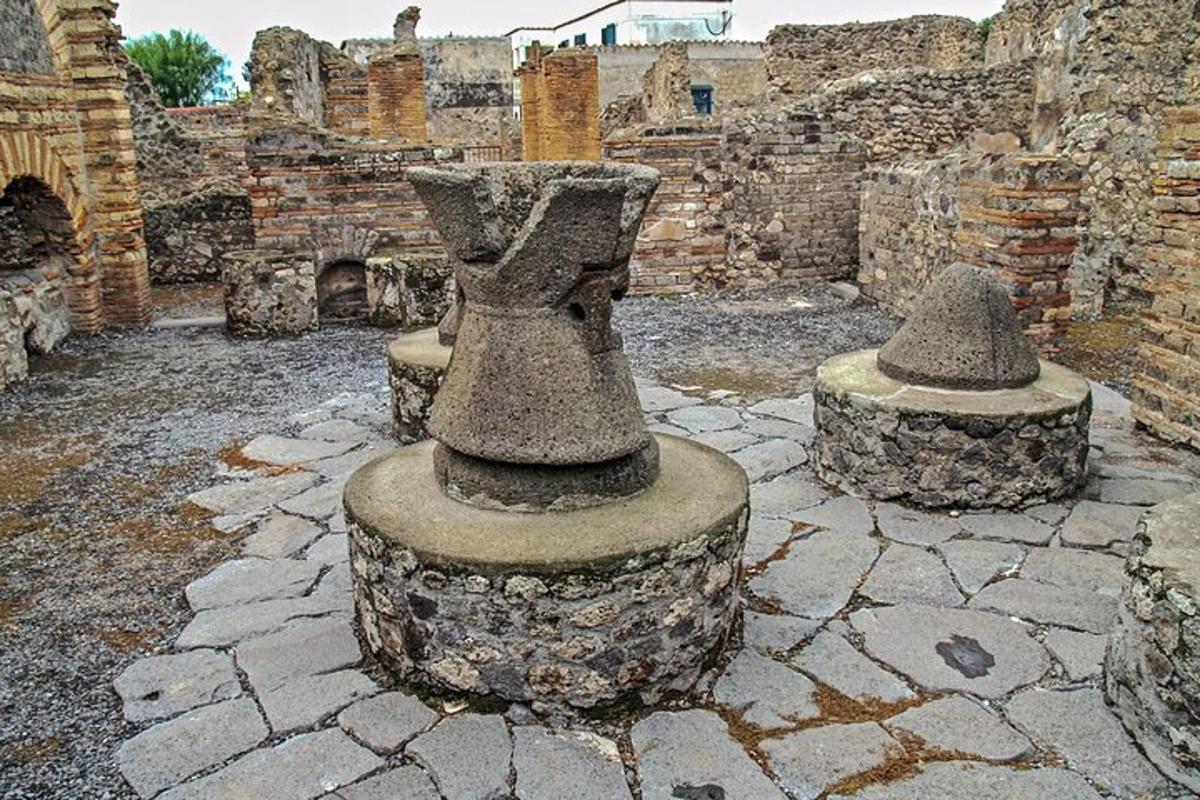 a group of stone vases sitting on a stone courtyard