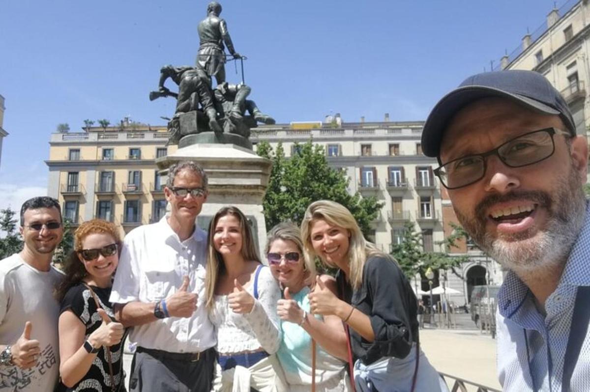 a group of people standing in front of a statue