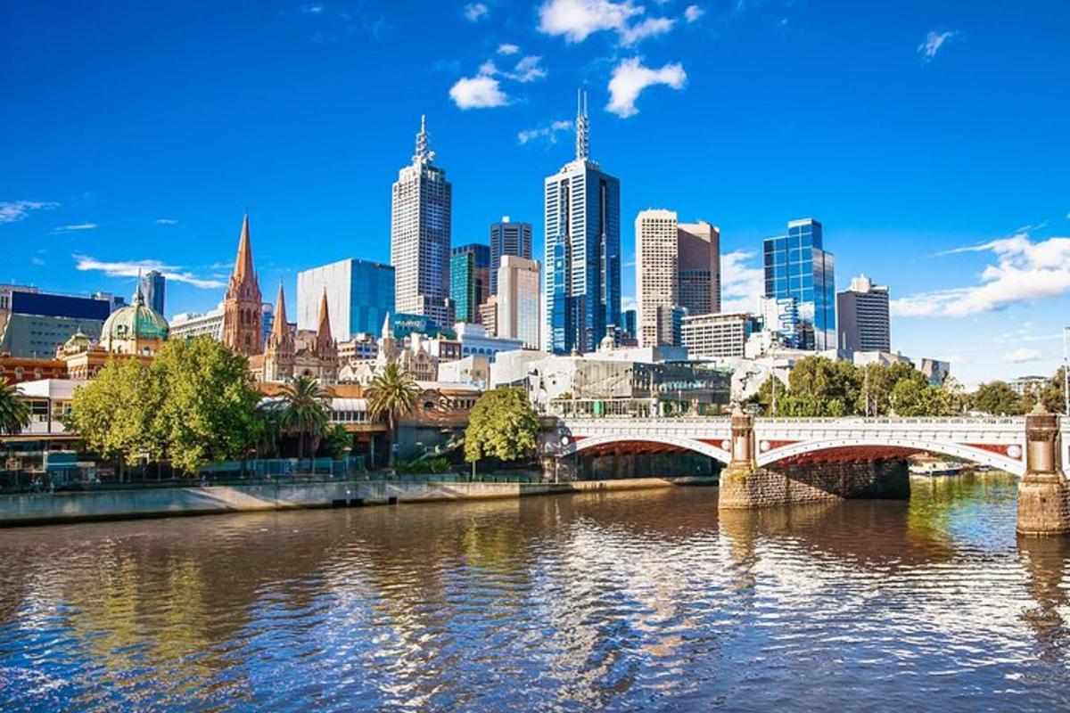 a city skyline with a bridge over a river