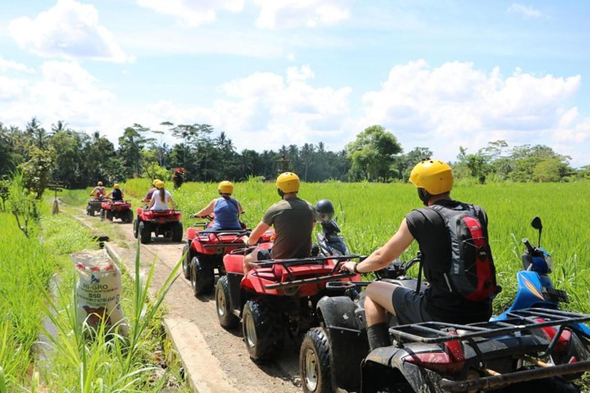 a group of people riding atvs down a dirt road