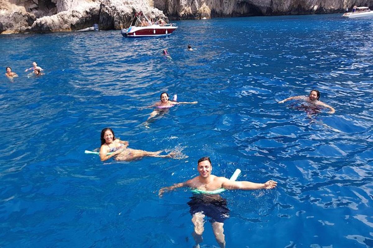 a group of people swimming in the blue water