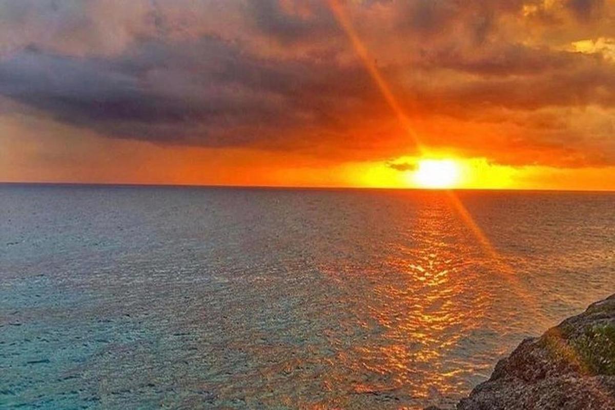 a sunset over the ocean with the sun setting