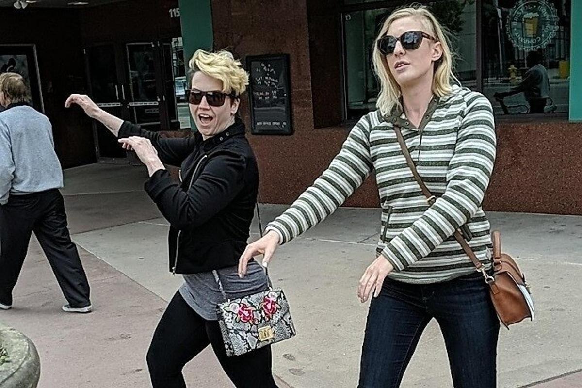 a man and a woman walking down a sidewalk