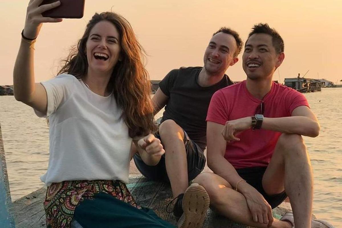 một nhóm ba người đang ngồi trên mặt nước