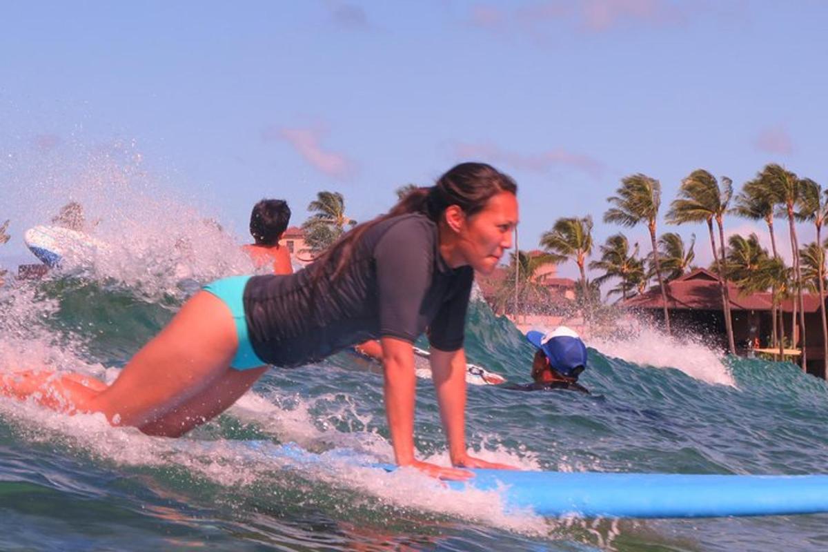 a woman riding a wave on a surfboard in the ocean