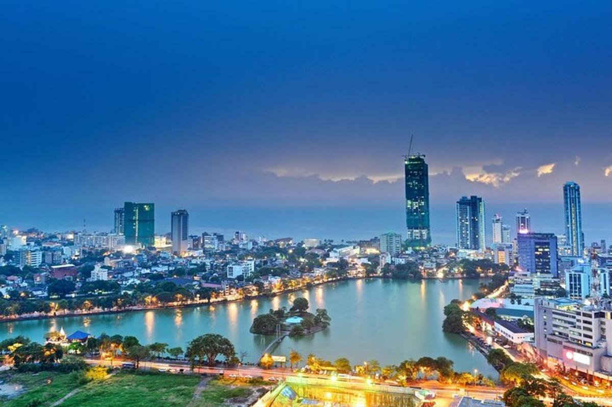 a city skyline at night with a river and buildings
