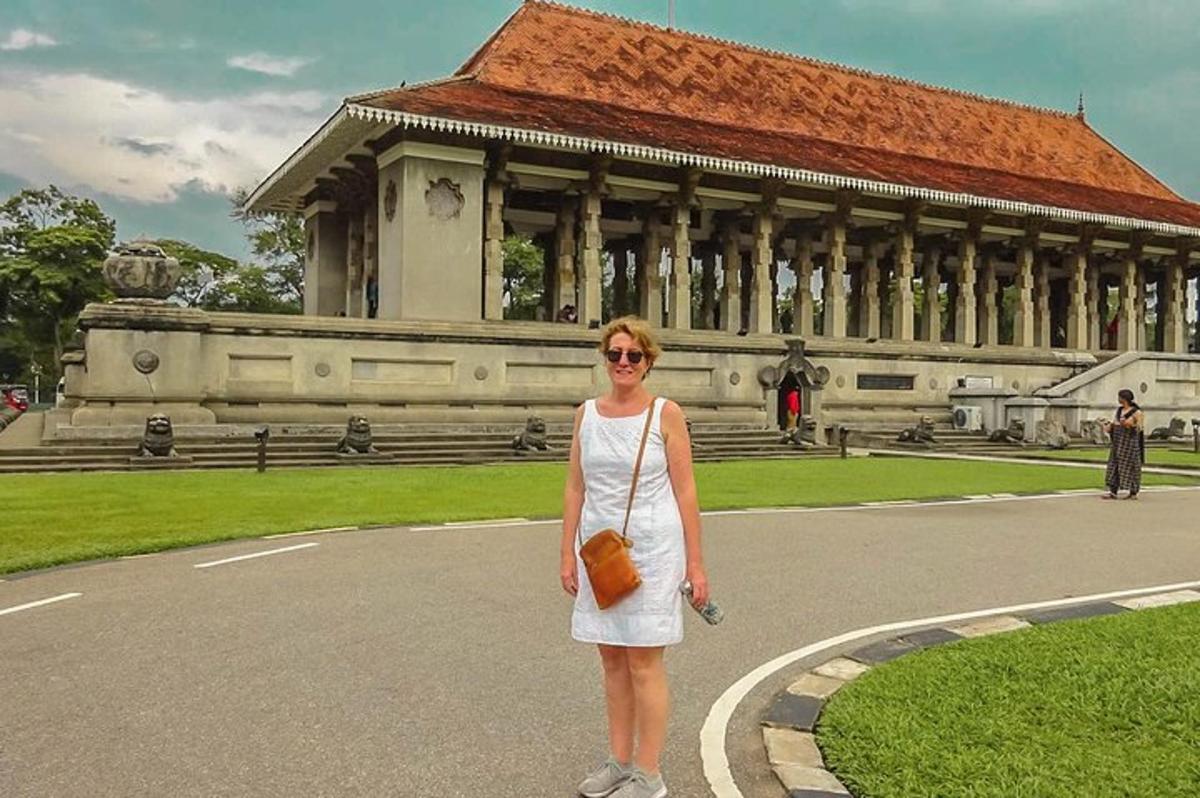a woman in a white dress standing in front of a building