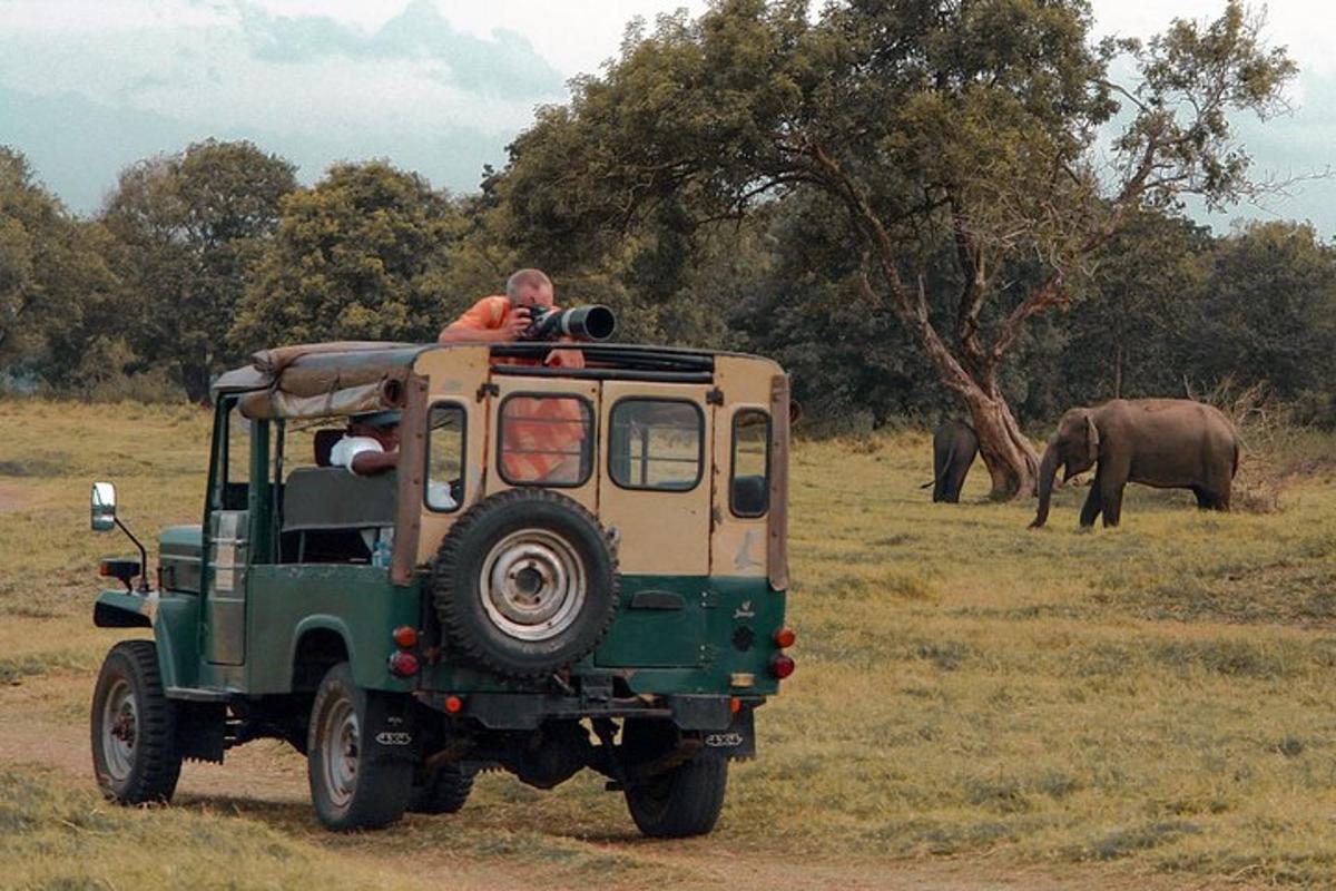 a man riding on the back of a green jeep