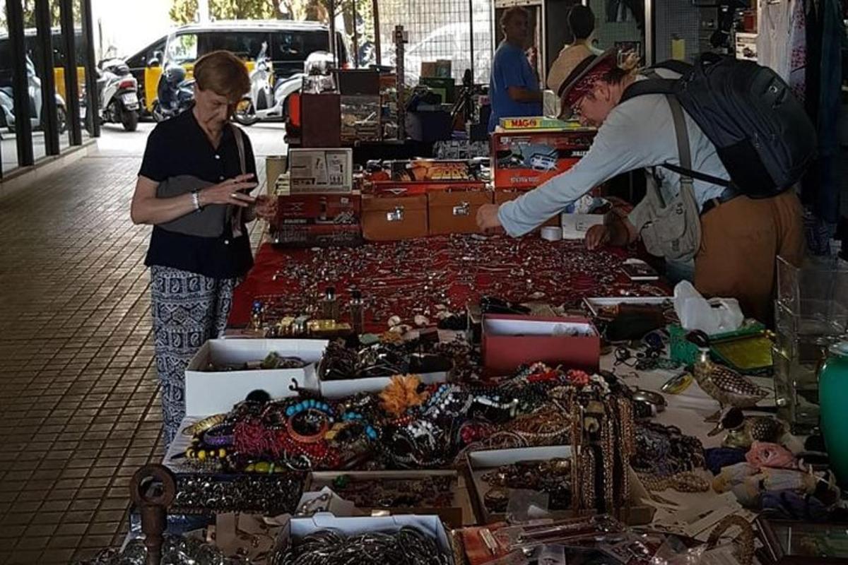 дві жінки стоять перед ринком з товарами