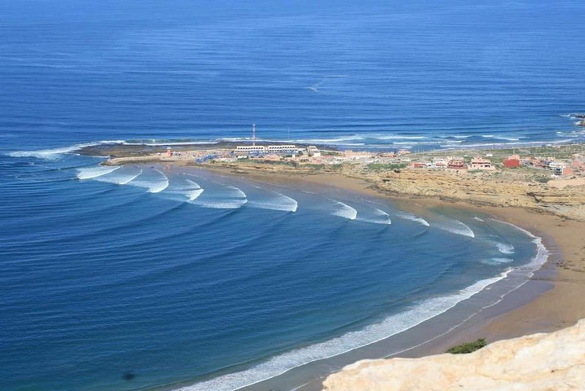 an aerial view of a beach with houses and the ocean