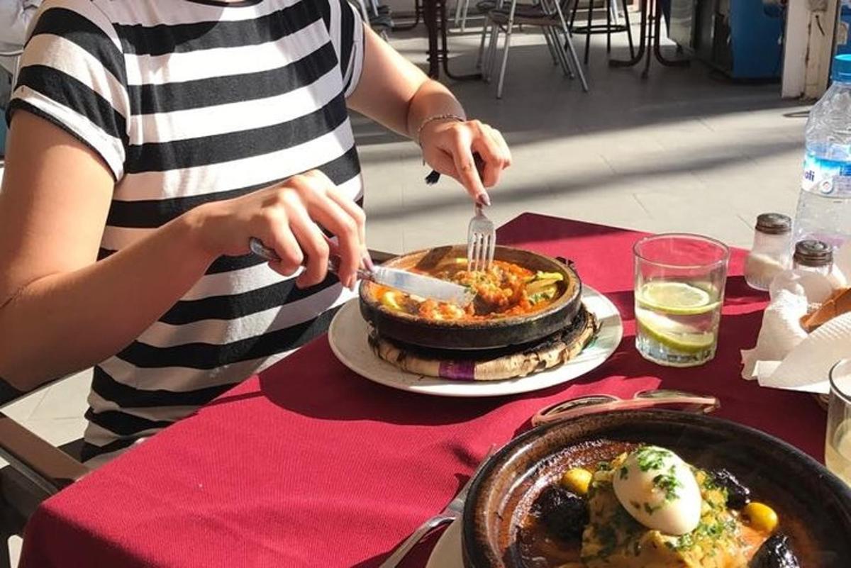 a woman is eating food on a table