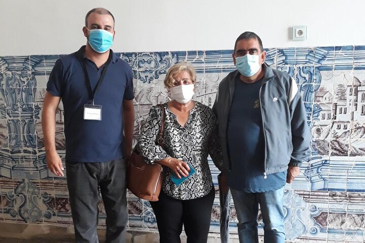 a group of people wearing masks in front of a wall