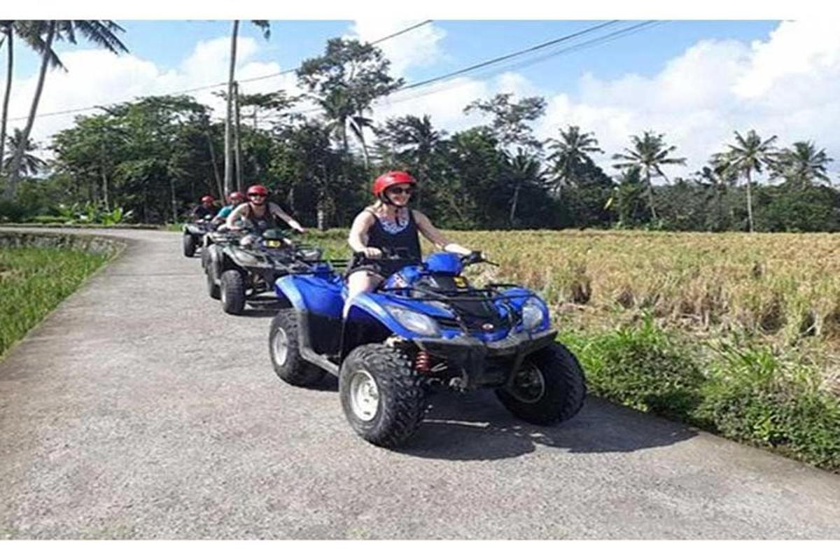 a group of people riding atvs down a road