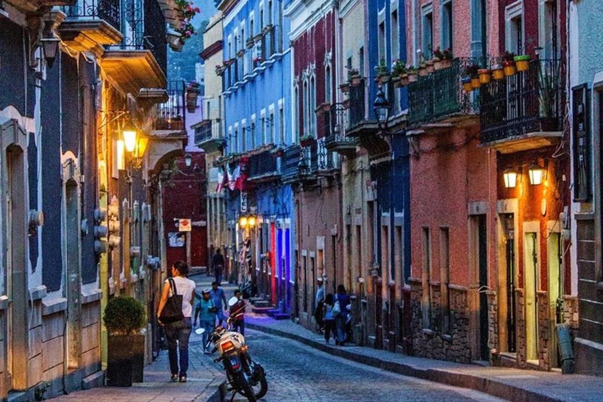 a group of people walking down a city street