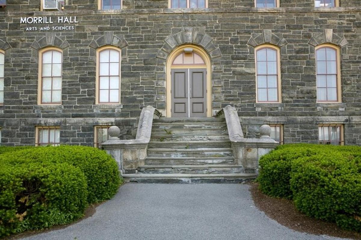 a stone building with stairs in front of a building
