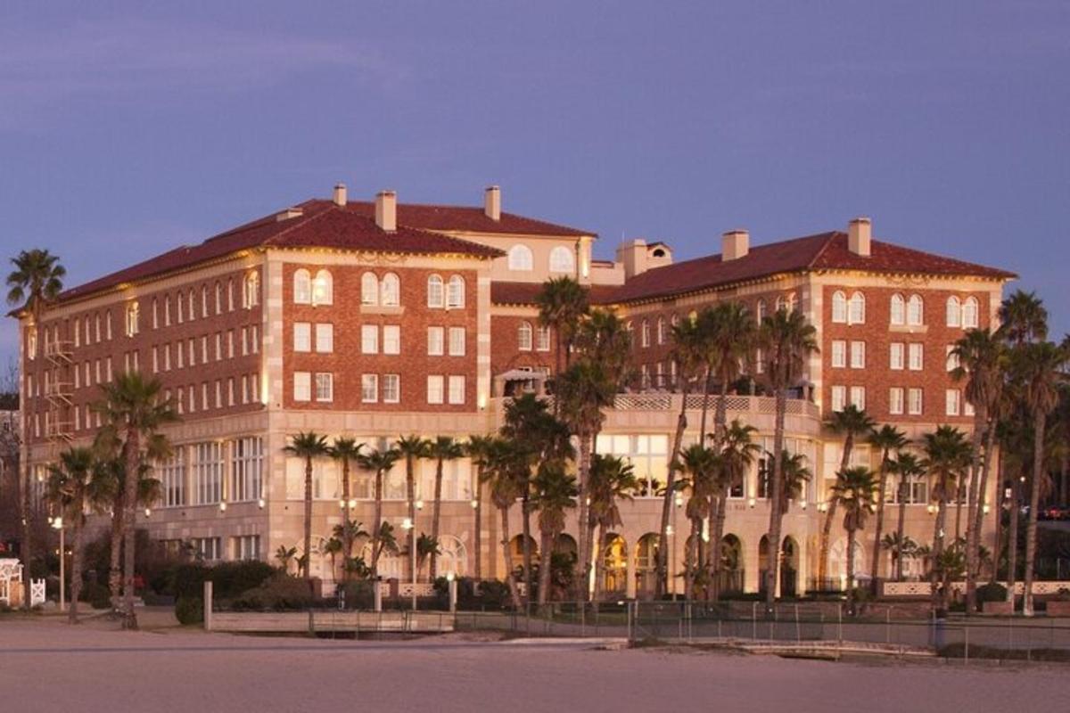 a large building with palm trees in front of it