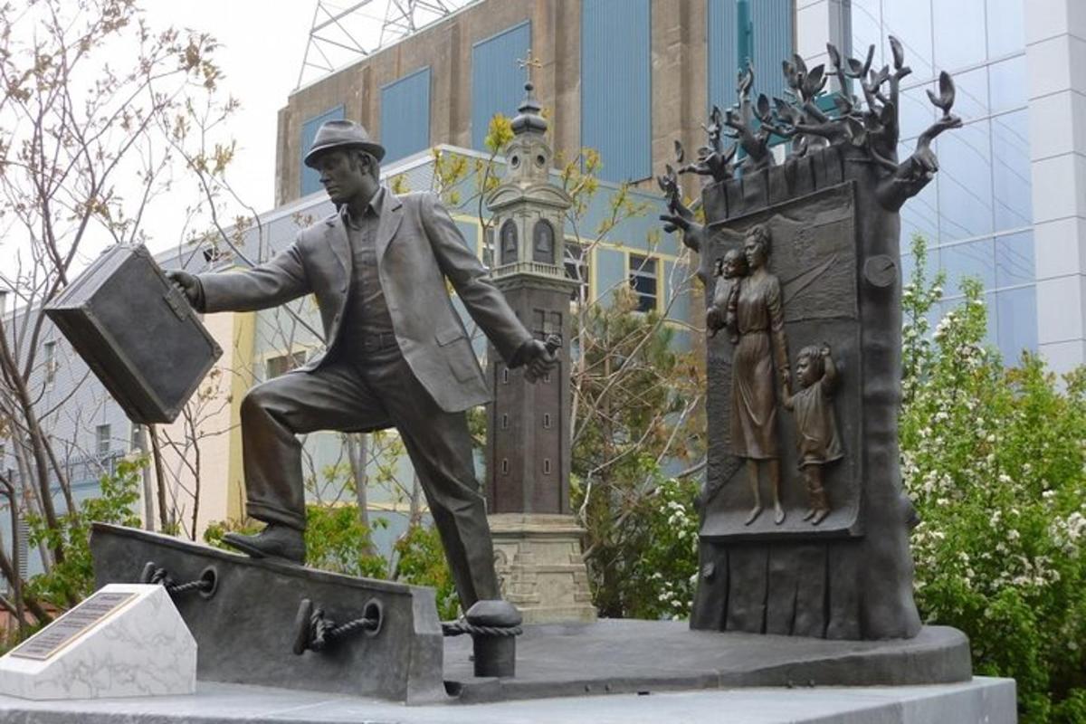 a statue of a man holding a briefcase next to a monument