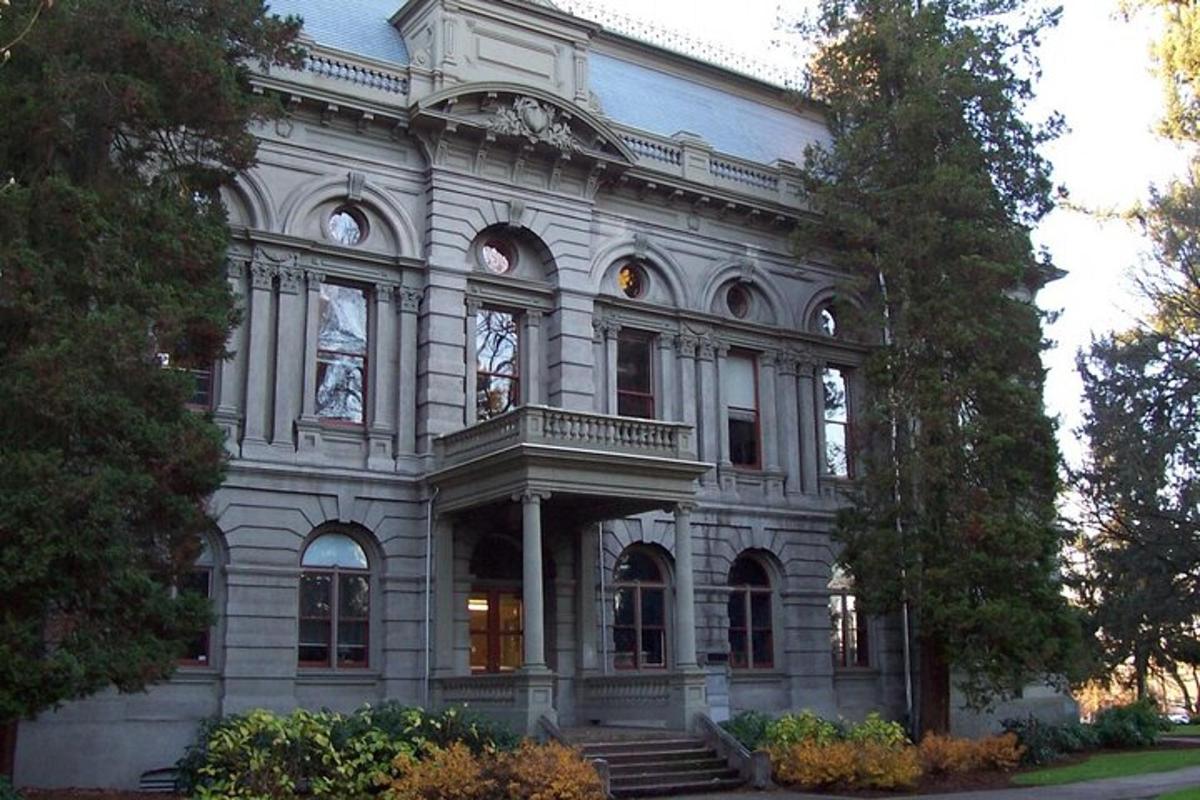 a large white building with stairs in front of it