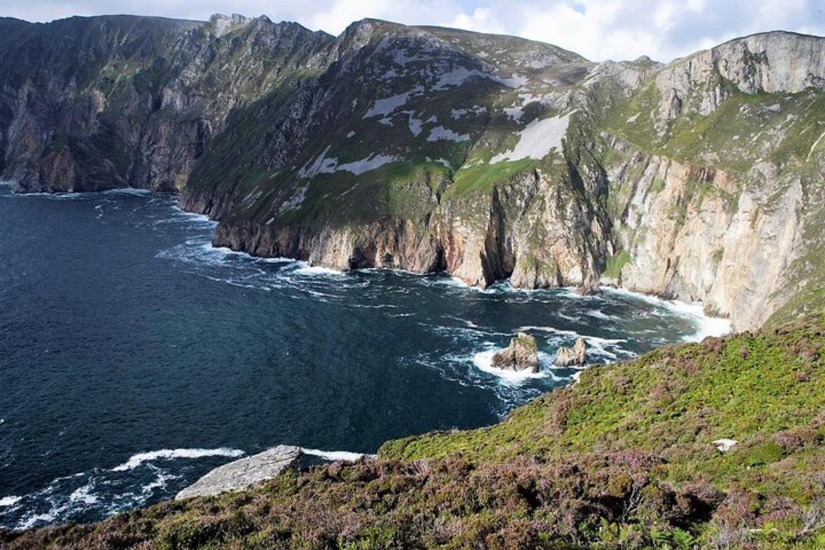 a view of the ocean and a rocky mountain