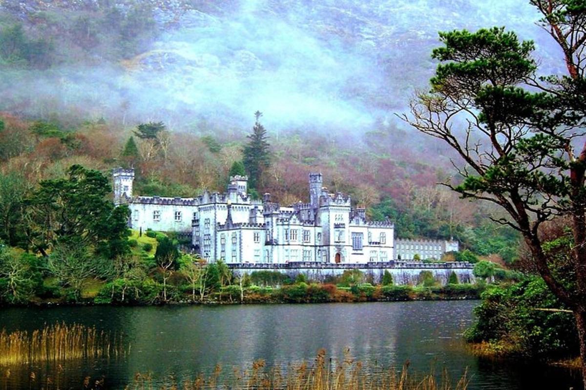 a large castle sitting on the side of a lake