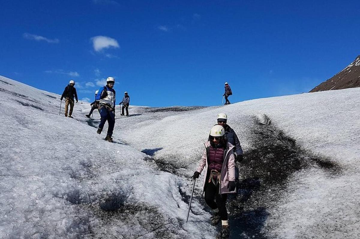 a group of people walking up a snow covered slope