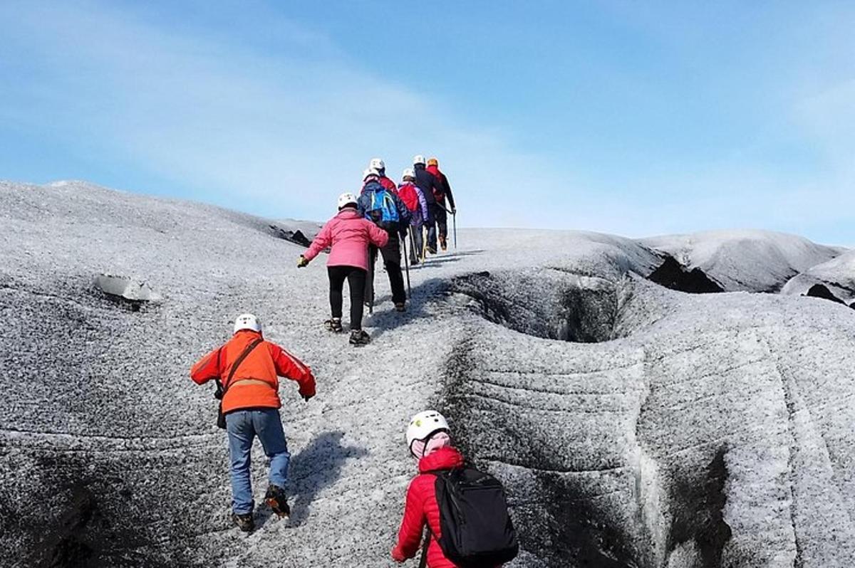 a group of people walking on top of a mountain