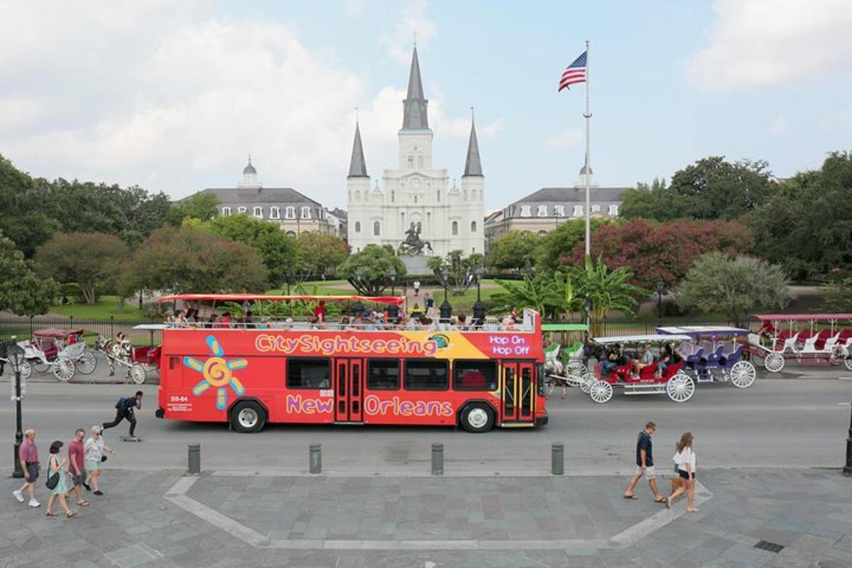 a red double decker bus in front of a building