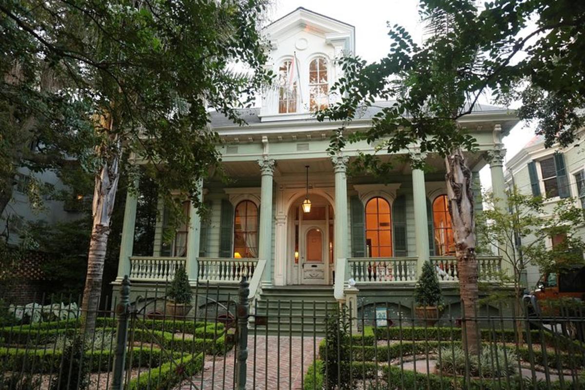 a white house with a fence in front of it